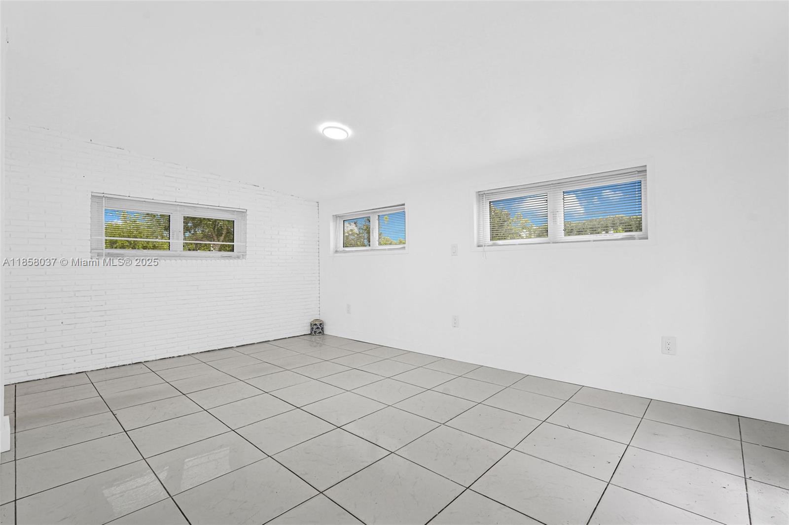 3711 Southwest 87th Avenue Miami, FL 33165 - Photo 9 of 92 a view of an empty room with a window