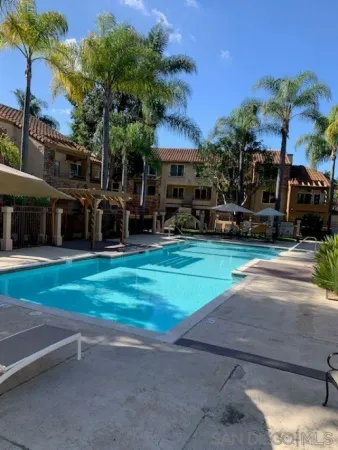 a view of a house with a yard and sitting area