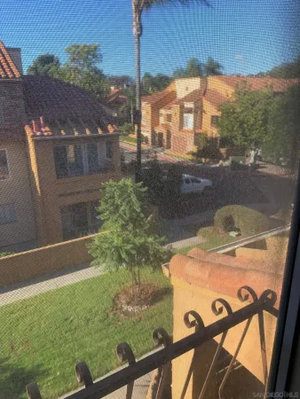 a view of a balcony with yard