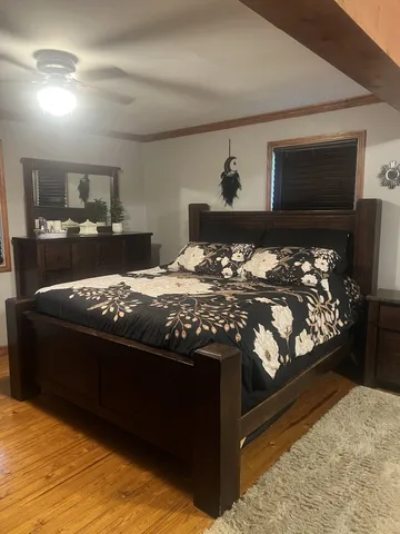 a bed sitting in a bedroom next to a lamp