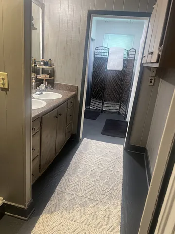 a spacious bathroom with a double vanity sink and a mirror