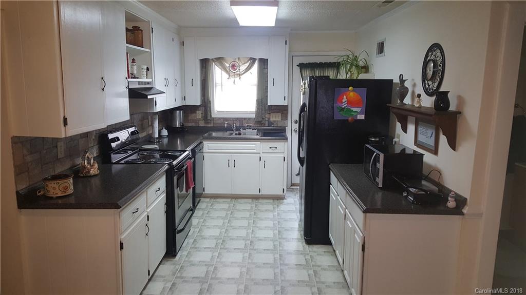 3220 Edwards Road Wingate, NC 28174 - Photo 4 of 21 a kitchen with a sink stove and refrigerator