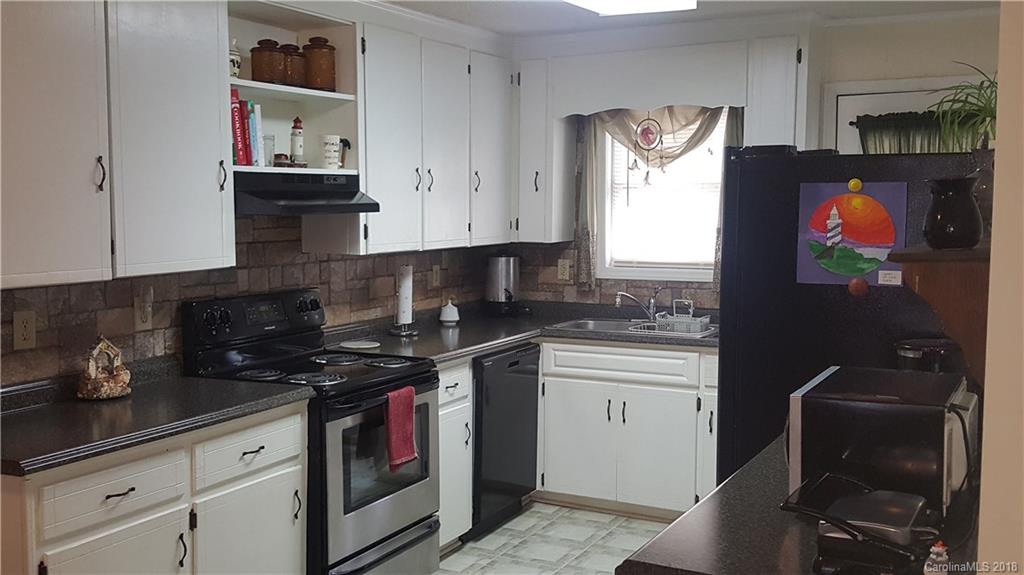 3220 Edwards Road Wingate, NC 28174 - Photo 5 of 21 a kitchen with stainless steel appliances granite countertop a stove a sink and a refrigerator