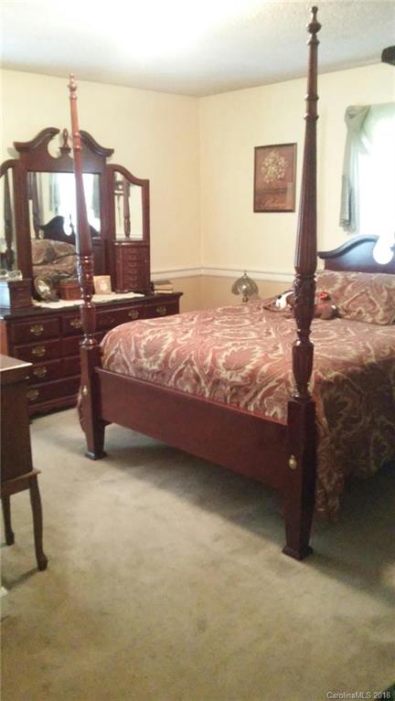3220 Edwards Road Wingate, NC 28174 - Photo 9 of 21 a bed sitting in a spacious bedroom next to a larger window