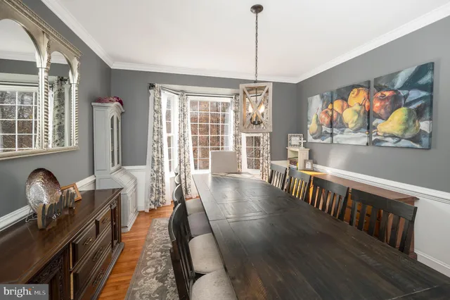 a view of a livingroom with furniture wooden floor and windows