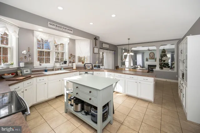 a kitchen with a sink window and cabinets