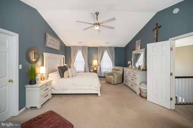 a bedroom with bed and white cabinets