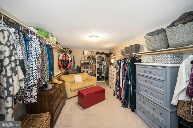 a view of walk in closet with clothes