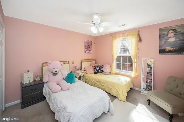 a bedroom with two beds and a chandelier
