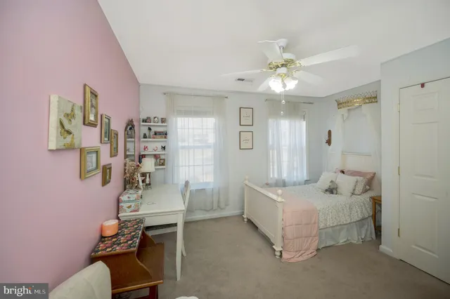 a spacious bedroom with a bed and a chandelier