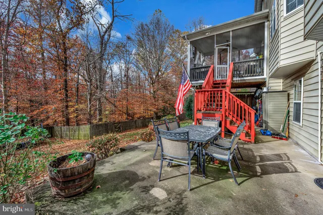a backyard of a house with barbeque oven table and chairs