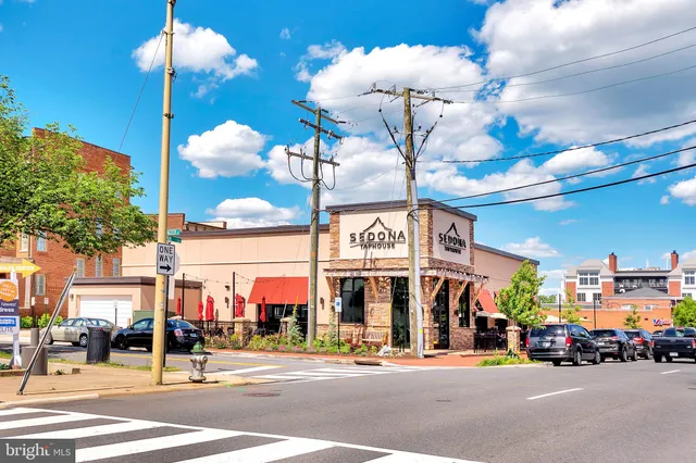 a view of a building with a umbrellas on a street