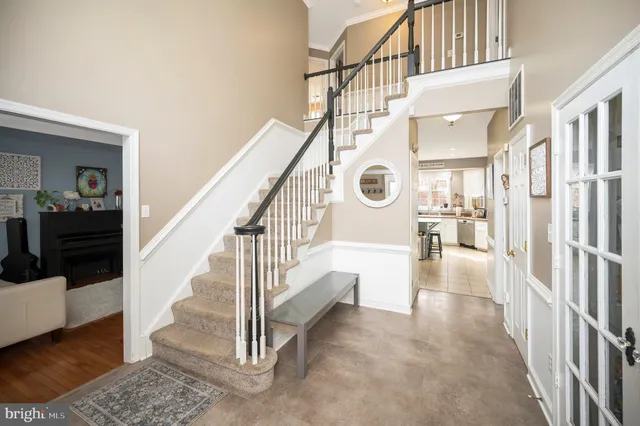 a view of staircase with lots of frames and a rug