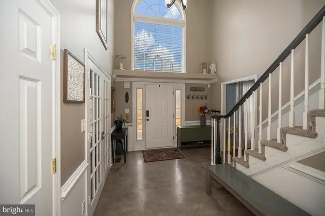 a view of hallway with stairs and wooden floor