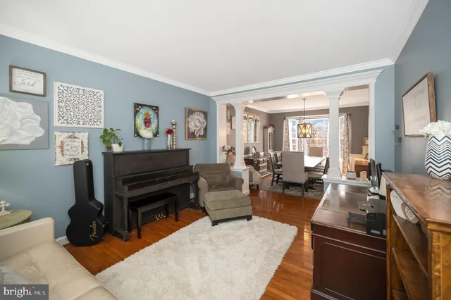 a living room with furniture a couch and a piano