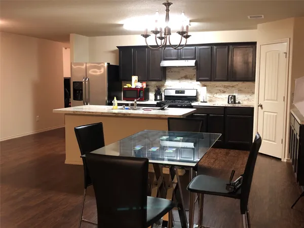a dining table with chairs and wooden floor