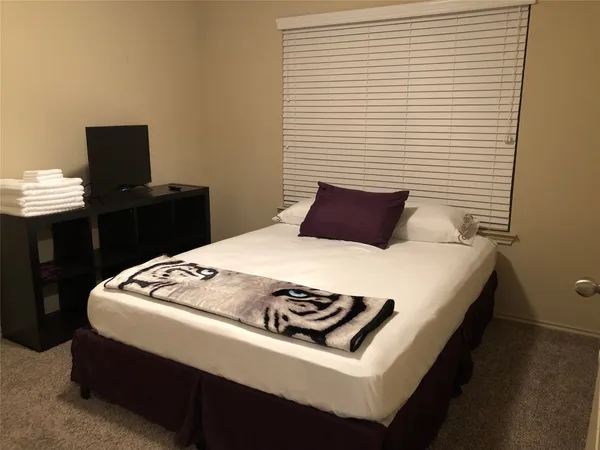 a bedroom with a bed and a desk