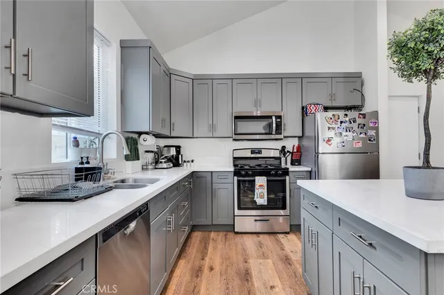 a kitchen with kitchen island a sink stainless steel appliances and cabinets
