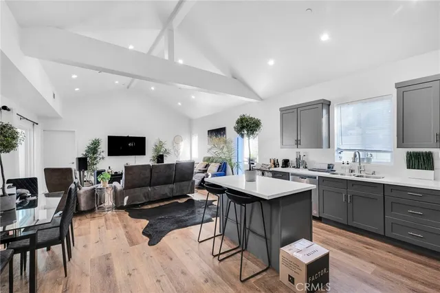 a view of kitchen with sink dining table and chairs