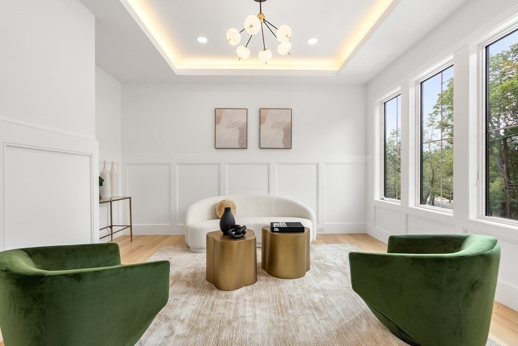 91 Oldham Road Newton, MA 02465 - Photo 2 of 38 a living room with kitchen island stainless steel appliances and a couch