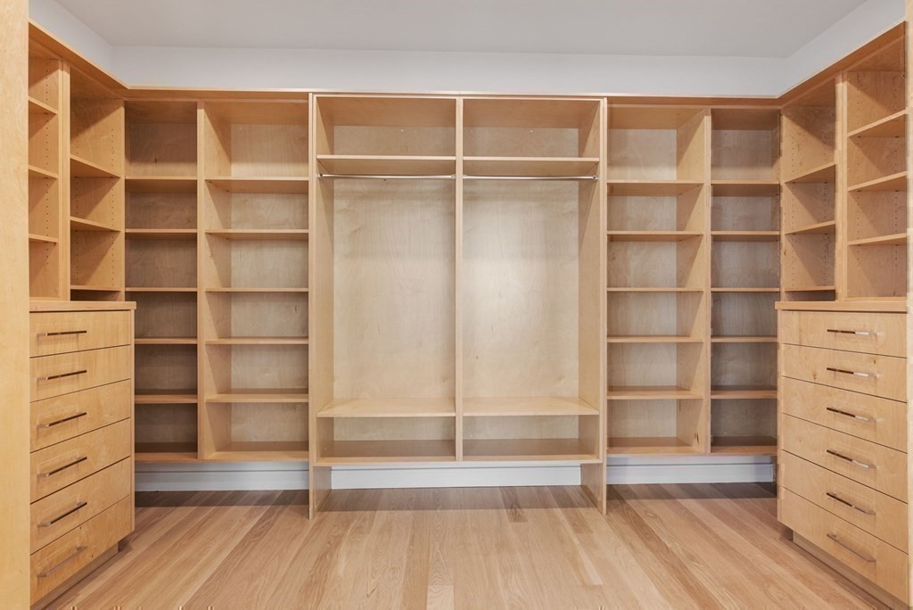 91 Oldham Road Newton, MA 02465 - Photo 21 of 38 a view of an empty room with wooden floor and shelves