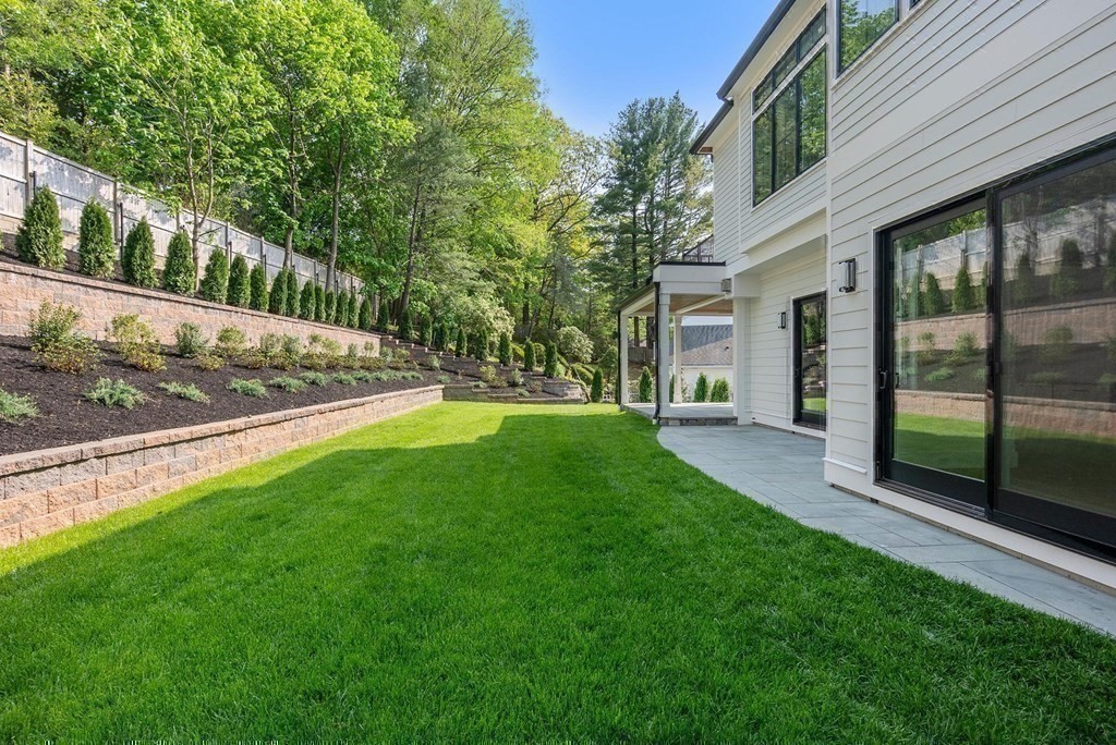 91 Oldham Road Newton, MA 02465 - Photo 27 of 38 a view of a house with a yard and a garden