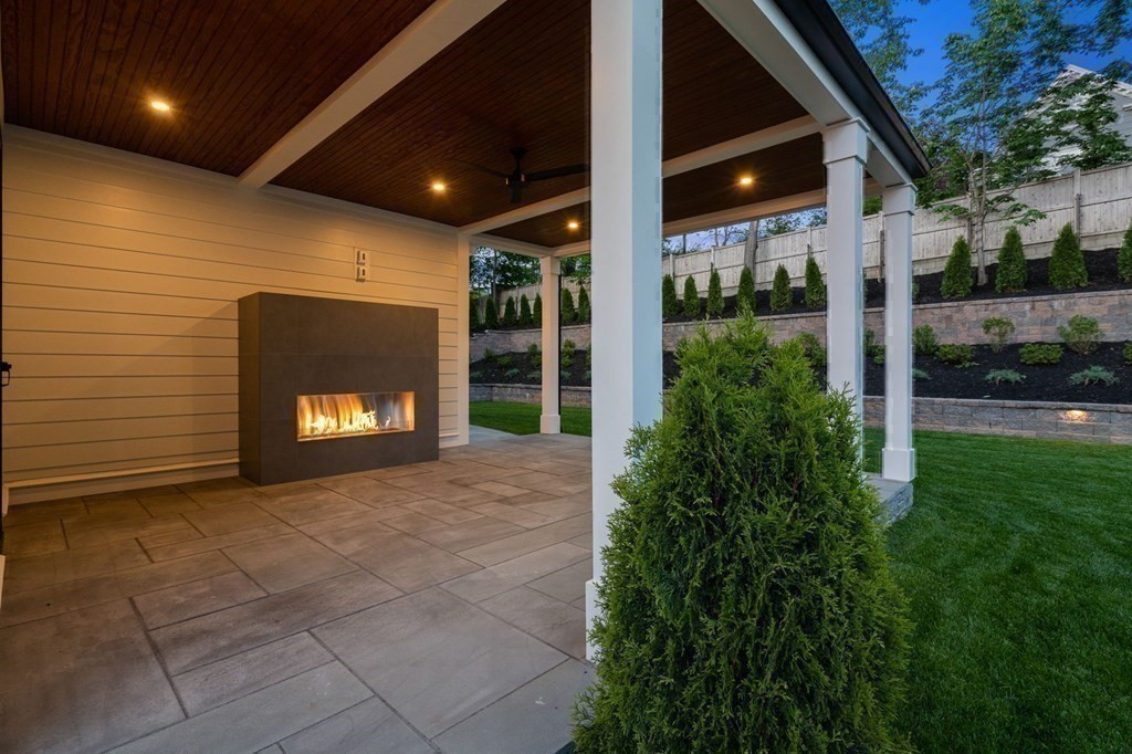 91 Oldham Road Newton, MA 02465 - Photo 30 of 38 a view of a hall with a fireplace and plants