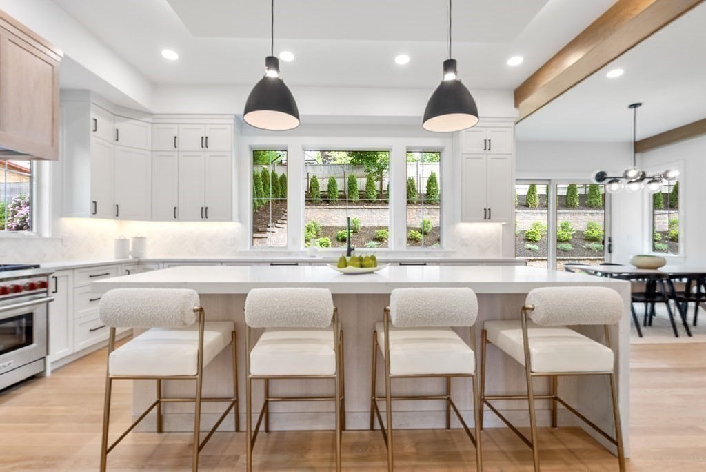 91 Oldham Road Newton, MA 02465 - Photo 5 of 38 a kitchen with a dining table chairs sink and white cabinets