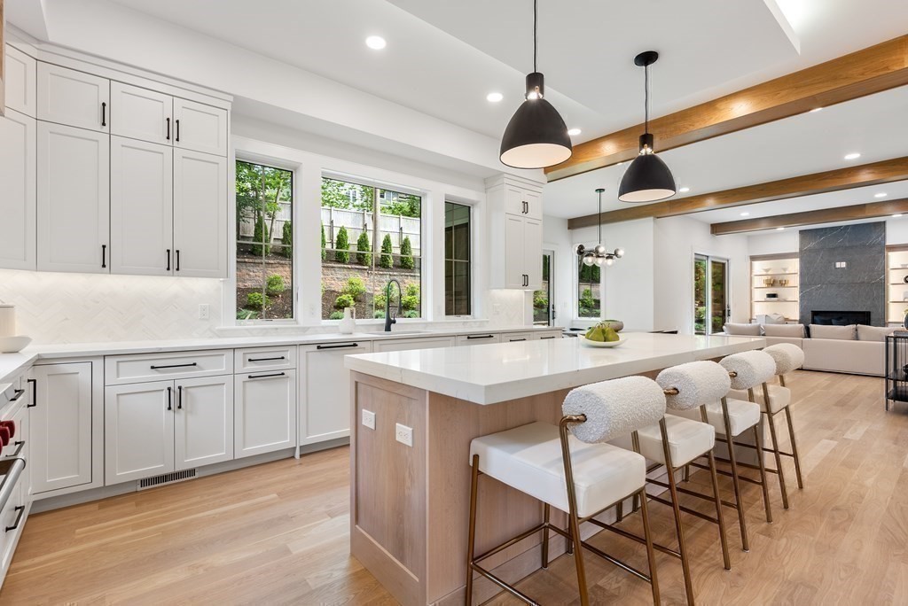 91 Oldham Road Newton, MA 02465 - Photo 10 of 38 a large kitchen with granite countertop lots of counter space dining table and stainless steel appliances