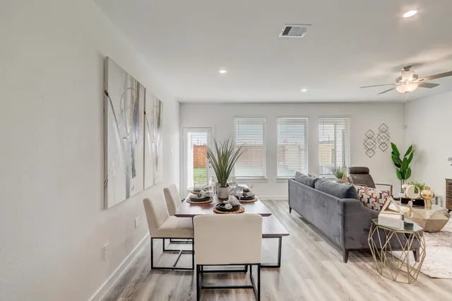 a living room with furniture potted plant and a window