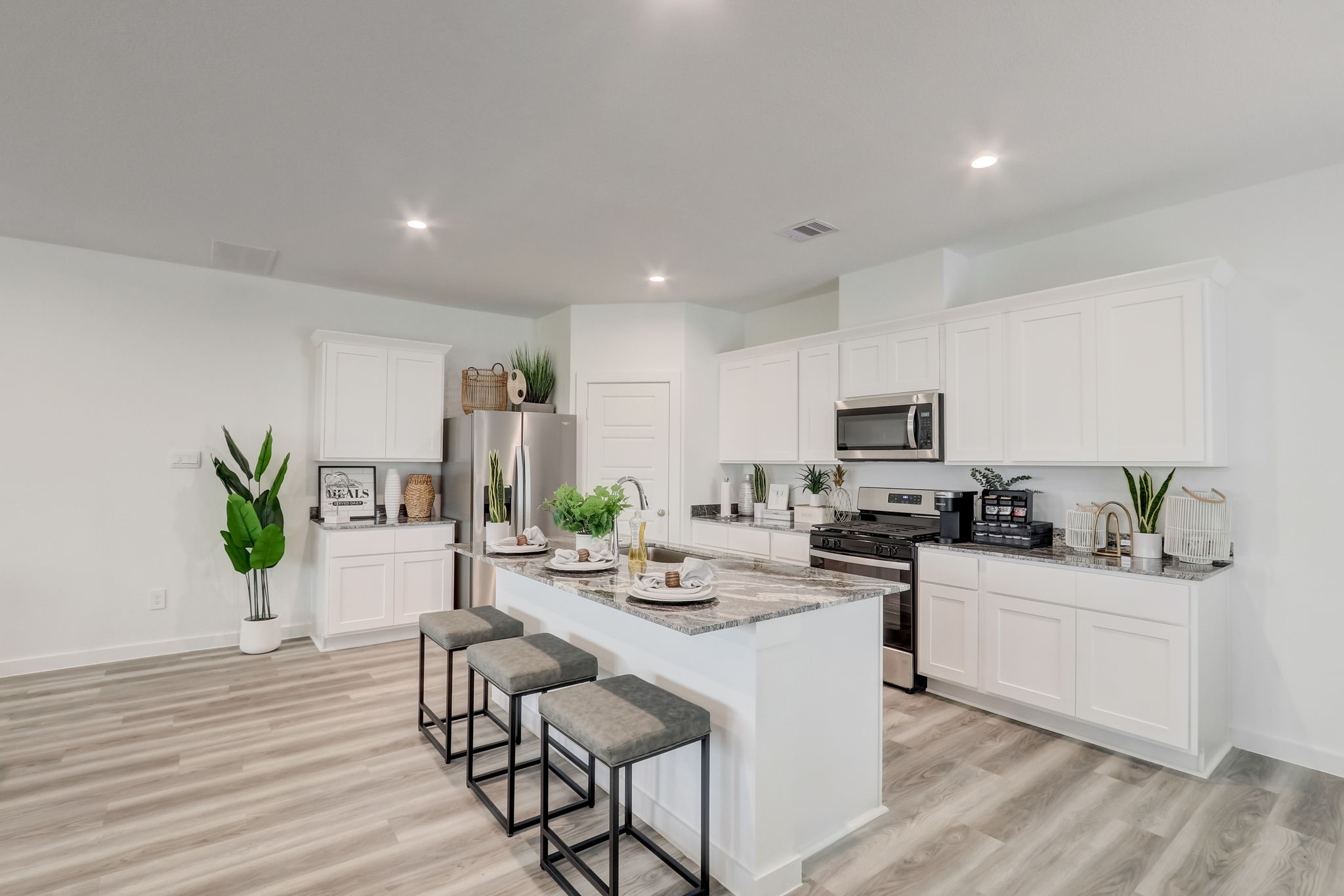 10409 Lancaster Frst Lane Houston, TX 77051 - Photo 15 of 50 a kitchen with stainless steel appliances kitchen island granite countertop a sink a stove a dining table and chairs with wooden floor