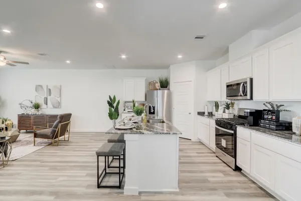 a kitchen with counter top space cabinets and appliances