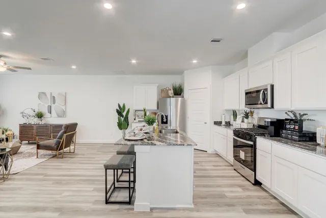 a kitchen with counter top space cabinets and appliances