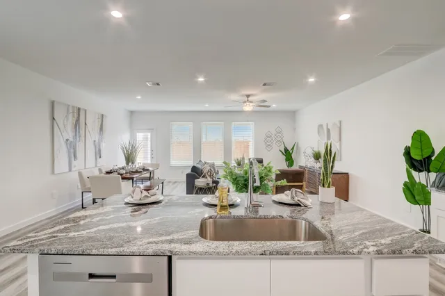 a kitchen with granite countertop a sink and a counter top space