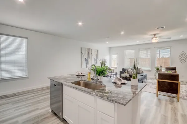 a kitchen with sink refrigerator and stove