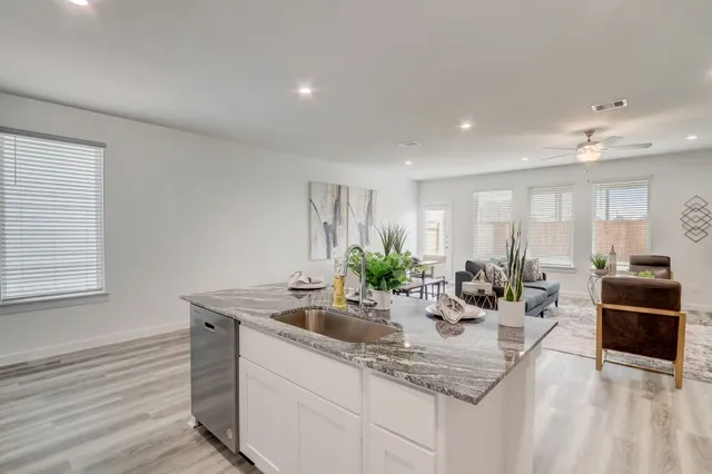 a kitchen with sink refrigerator and stove