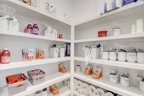 a cabinet with kitchen and lots of clutter on the kitchen