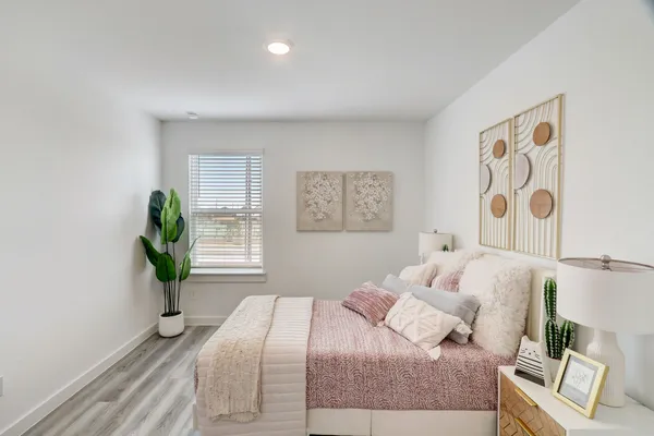 a bedroom with a bed and a window