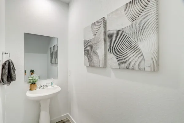 a view of bathroom with a sink and mirror