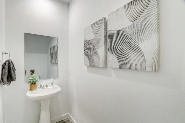 a view of bathroom with a sink and mirror