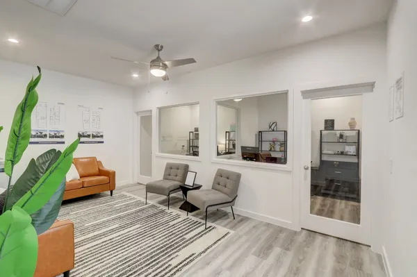a living room with furniture and a chandelier