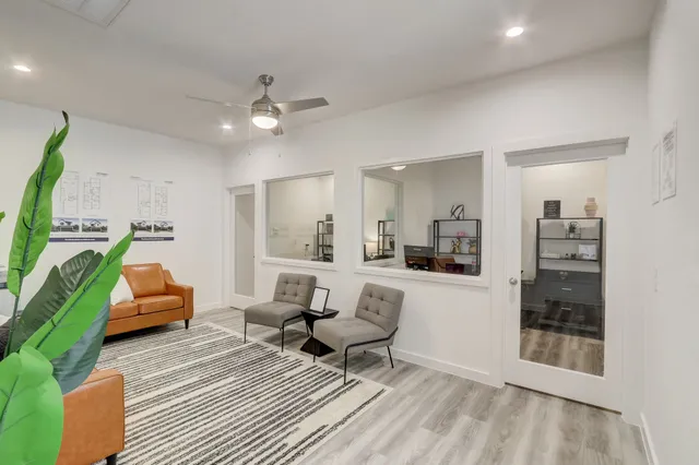 a living room with furniture and a chandelier