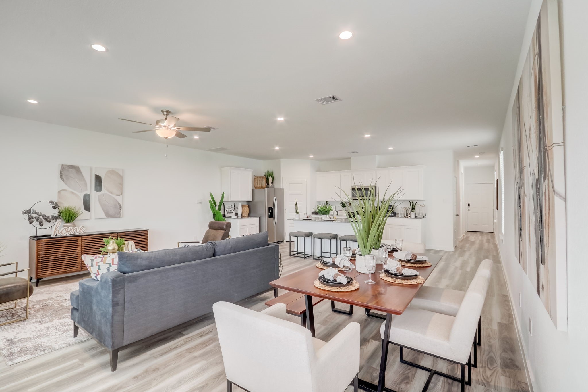 10409 Lancaster Frst Lane Houston, TX 77051 - Photo 6 of 50 a living room with furniture and a dining table with wooden floor