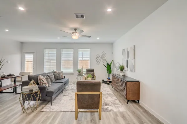 a living room with furniture and wooden floor