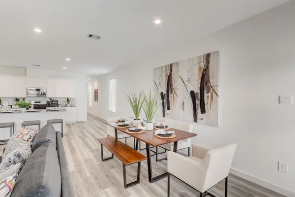 a living room with furniture a kitchen view and a kitchen view