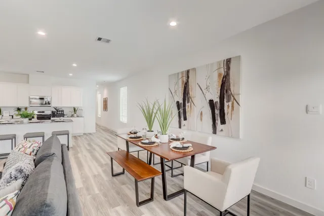 a living room with furniture a kitchen view and a kitchen view