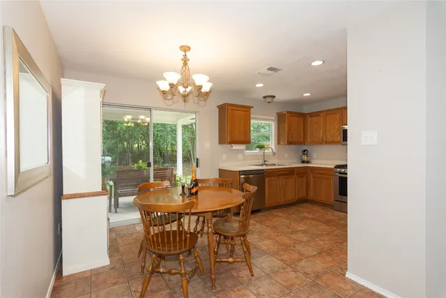 a view of a dining room with furniture wooden floor and chandelier
