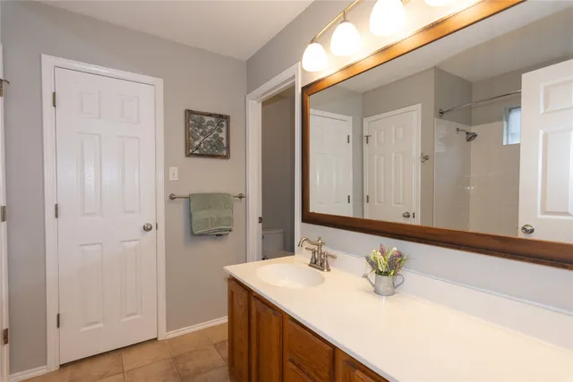 a bathroom with a sink vanity and a mirror