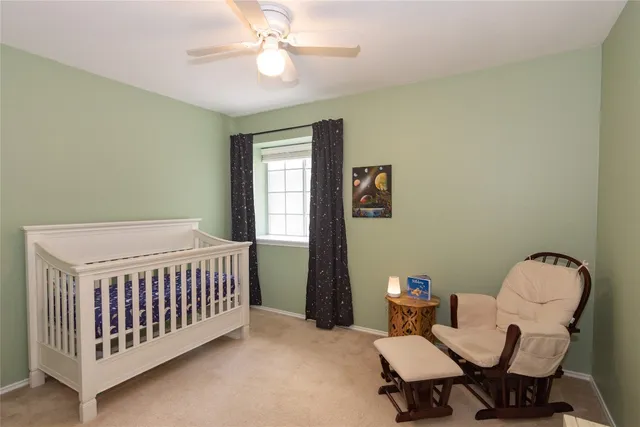 a bedroom with a bed and chair