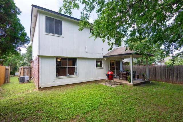 a view of a house with a yard and sitting area